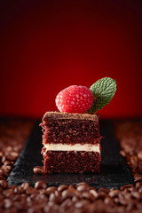 Closeup of chocolate cake with raspberry .