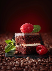 Closeup of chocolate cake with raspberry .