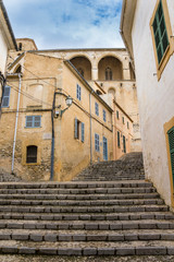 Fototapeta na wymiar Mallorca, Narrow stairway through old town of Arta upstairs to cathedral