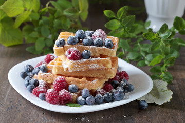  Yummy sweet waffles with raspberries and blueberries.