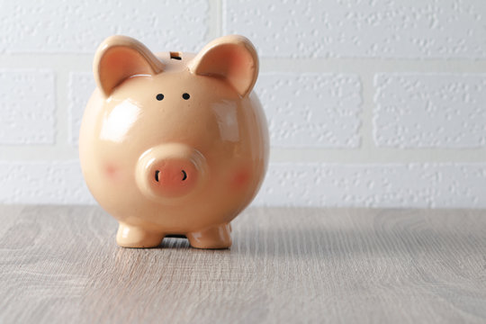 Piggy Bank On The Wooden Table With Copy Sapce