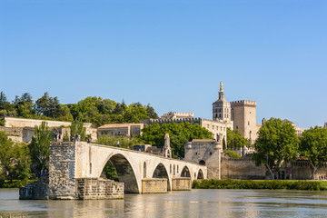 Fototapeta na wymiar The Saint-Benezet bridge, also known as Avignon bridge, and the Papal palace, with the Notre-Dame des Doms cathedral and Campane tower, are part of the most important medieval Gothic complex worldwide