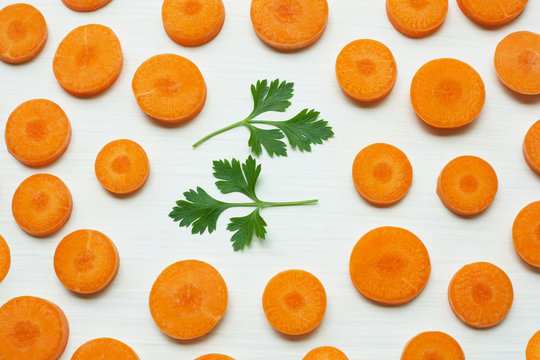 Chopped carrot slices with parsley leaves.