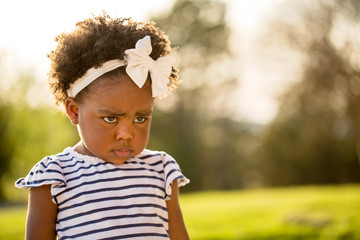 African American little girl with a mad expression.
