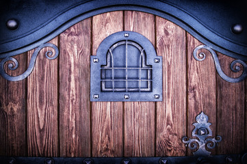 wooden gate with forged trim and window