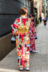 KYOTO, JAPAN - NOVEMBER 7, 2017: Girls in a kimono on a city street. Vertical. Copy space for text.