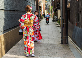 Fototapeta na wymiar KYOTO, JAPAN - NOVEMBER 7, 2017: Girls in a kimono on a city street. Copy space for text.