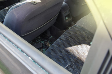 A criminal incident. Hacking the car. Broken left side window of a car