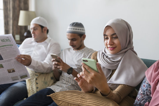 Muslim friends using social media on phones