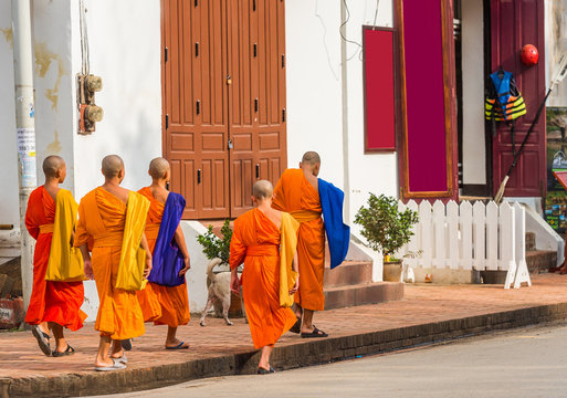 LUANG PRABANG, LAOS - JANUARY 11, 2017: Monks on a city street. Copy space for text.