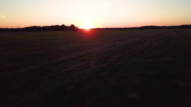 A beautiful brunette with long hair in a white shirt and jeans runs across the field to meet the sunset. Dancing at dawn! Inspiring video. 
