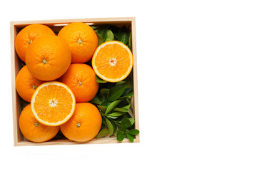 Fresh orange citrus fruit in wooden box.