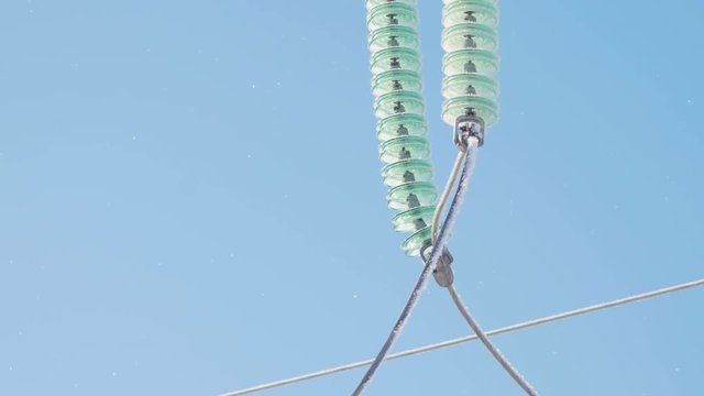ceramic isolators covered with hoarfrost on tower