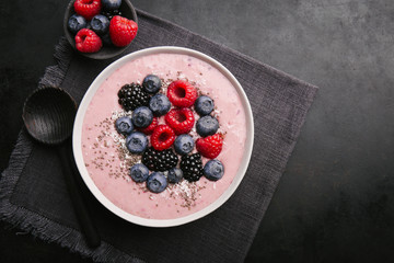 Smoothie bowl on white plate on dark background