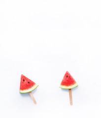 Watermelon slice popsicles on white background