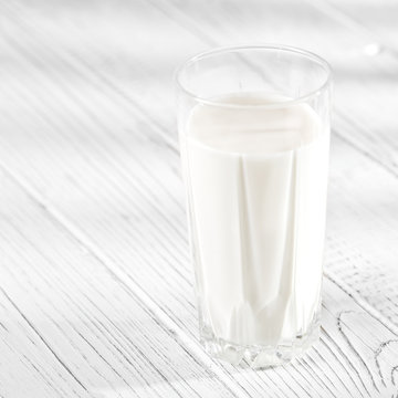 A glass of delicious milk. Square. The concept is healthy food, breakfast, vegetarianism.