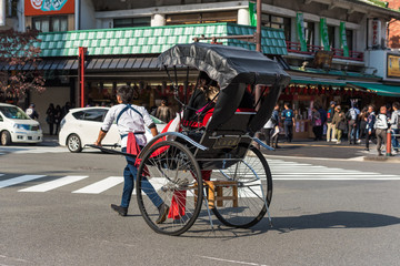 Fototapeta na wymiar TOKYO, JAPAN - OCTOBER 31, 2017: Rickshaw on the city street. Copy space for text.