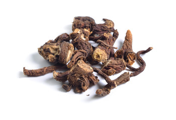 Dried medicinal herbs raw materials isolated on white. Root of Taraxacum, known as dandelions