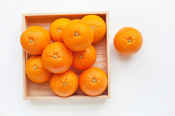 Fresh orange citrus fruit in wooden box.