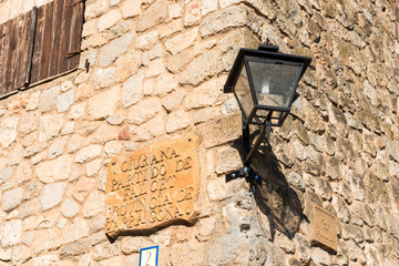 SIURANA DE PRADES, SPAIN - OCTOBER 5, 2017: Nameplate on the facade of the building. Close-up.