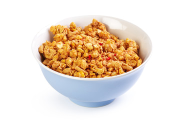 Bowl of homemade granola with fruit pieces isolated on white