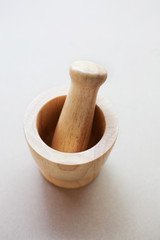 Wooden mortar on white background.