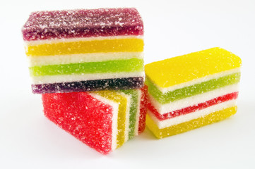 Sliced ​​multicolored marmalade on a light background