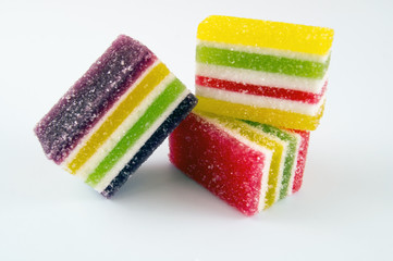 Sliced ​​multicolored marmalade in strips on a light background