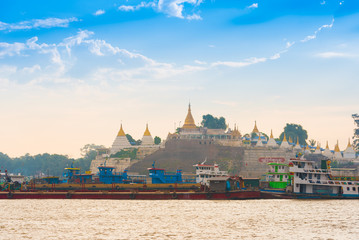 MANDALAY, MYANMAR - DECEMBER 1, 2016: Port on a background of golden pagodas, Burma. Copy space for text.