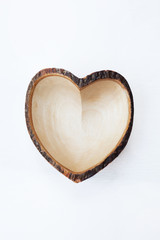 Empty wooden dish heart shape on white