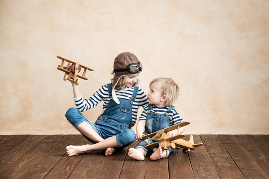 Happy children playing with toy airplane