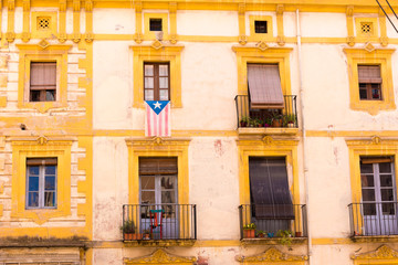 TARRAGONA, SPAIN – MAY 1, 2017: Facade of Spanish house with balconies and flowers. Close-up.