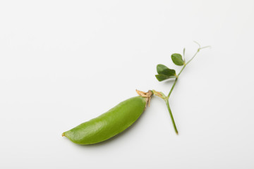 top view of green pea pod on white surface