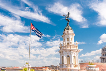 Fototapeta premium CUBA, HAVANA - MAY 5, 2017: The building of the Havana grand theater. Cuban flag. Copy space for text.