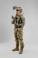 Special forces soldier with rifle on white background.