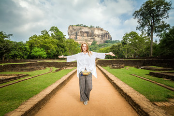 Sigiriya, Sri Lanka. A girl stands in the background of the famous mountain