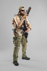 Special forces soldier with rifle on white background.