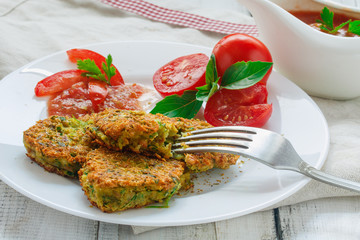Vegan cutlets, pancakes with young peas and tomato sauce. Close-up