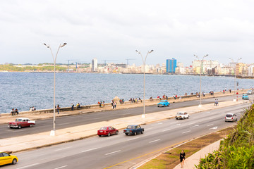 CUBA, HAVANA - MAY 5, 2017: Cars drive along the Malecon waterfront. Copy space for text.