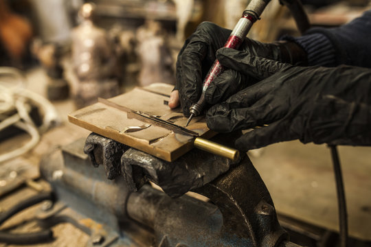 Employee working on details on metal piece