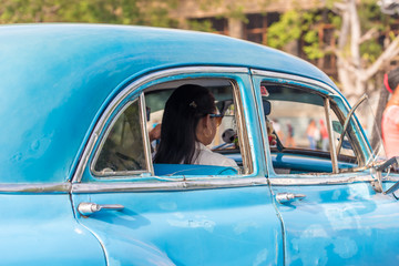 CUBA, HAVANA - MAY 5, 2017: A blue American retro car on a city street. Copy space for text. Close-up.