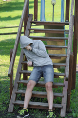 Drug addic, who has just got a dose of drugs, hides with the hoo