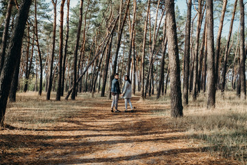 Fototapeta premium Fashion engagement shooting for beautiful couple. Couple in love has fun and laughs. Young hipster people hugging each other in park. Love story.