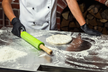 chef making dough for pizza. Man hands preparing bread. Concept of baking and patisserie