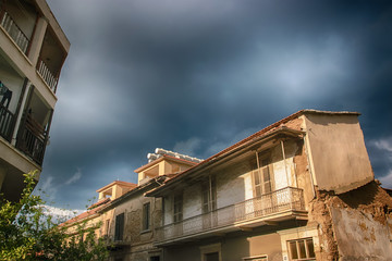 Detail of an abandoned building in cloudy landscape