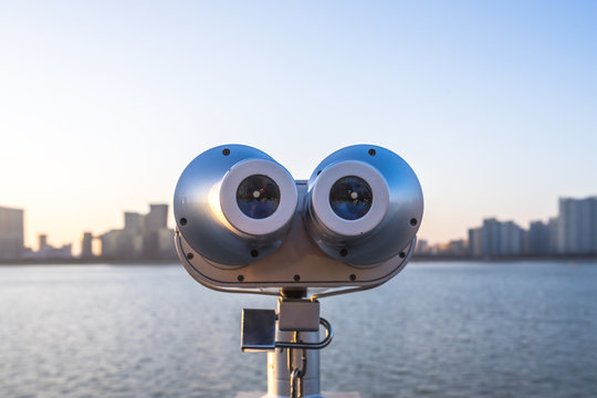 Telescope With City Skyline