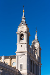 Fototapeta premium MADRID, SPAIN - SEPTEMBER 26, 2017: Cathedral Almudena on the blue sky backgroun. Copy space for text. Vertical.