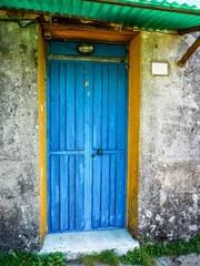 Old blue door in Tuscan village, Italy
