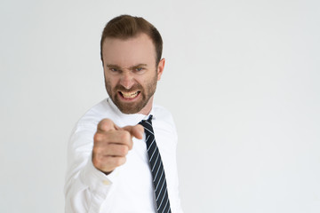 Mad boss choosing you. Young formally dressed man with angry grimace pointing finger at camera....