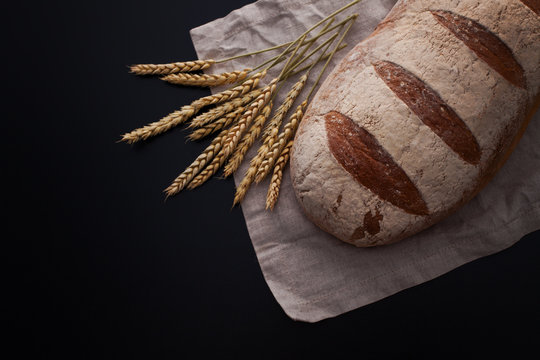 loaf of bread on black background